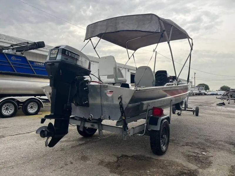 Slide: The Image of 1990 Bass Tracker Pro 17 boat with Evinrude motor and canopy on trailer. - 6