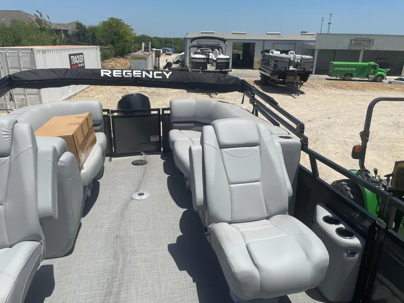 Slide: The Image of 2024 Regency 230 DL3 pontoon boat interior with gray seating and spacious layout. - 8