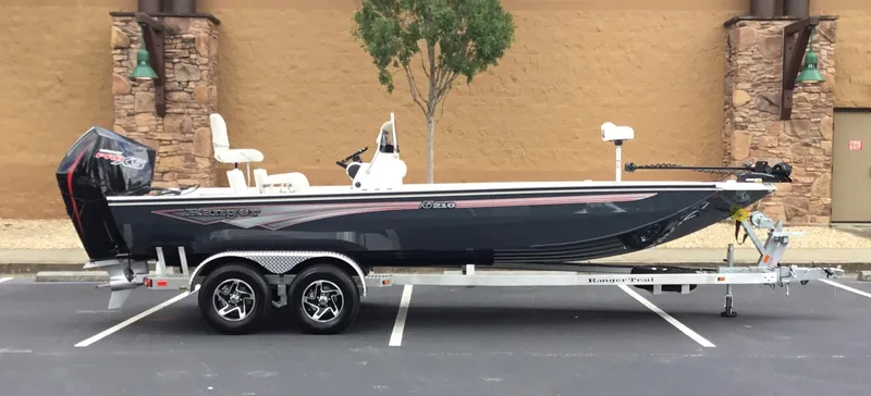 Slide: The Image of 2024 Ranger RB210 boat on a trailer, parked in a lot. - 1