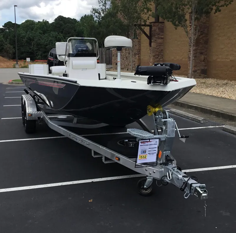 Slide: The Image of 2024 Ranger RB210 boat on trailer in parking lot. - 2