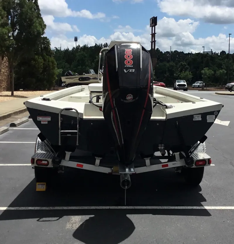 Slide: The Image of 2024 Ranger RB210 boat with 200 V6 engine on trailer in parking lot. - 9