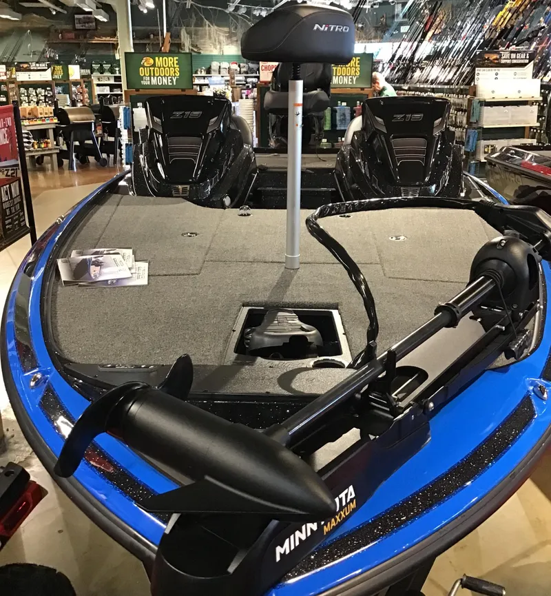 Slide: The Image of 2024 Nitro Z19 boat with Minn Kota trolling motor in showroom. - 2