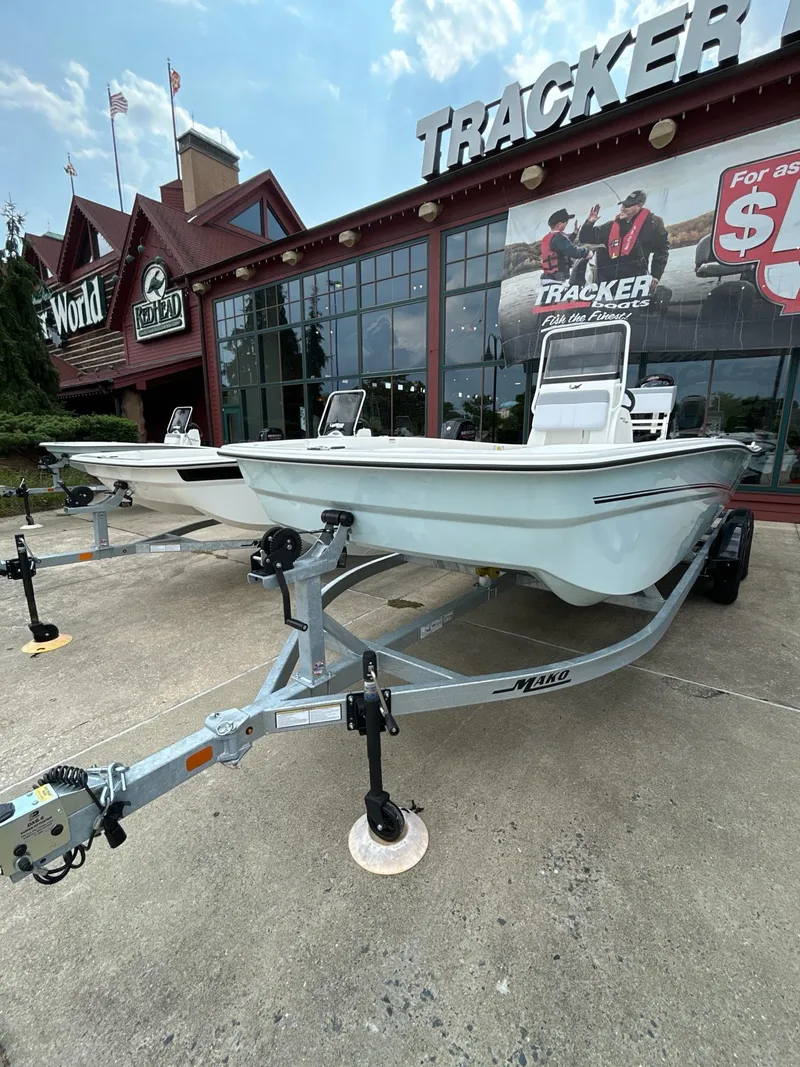 Slide: The Image of 2024 Mako Pro Skiff 19 CC boat on trailer outside Tracker store. - 3