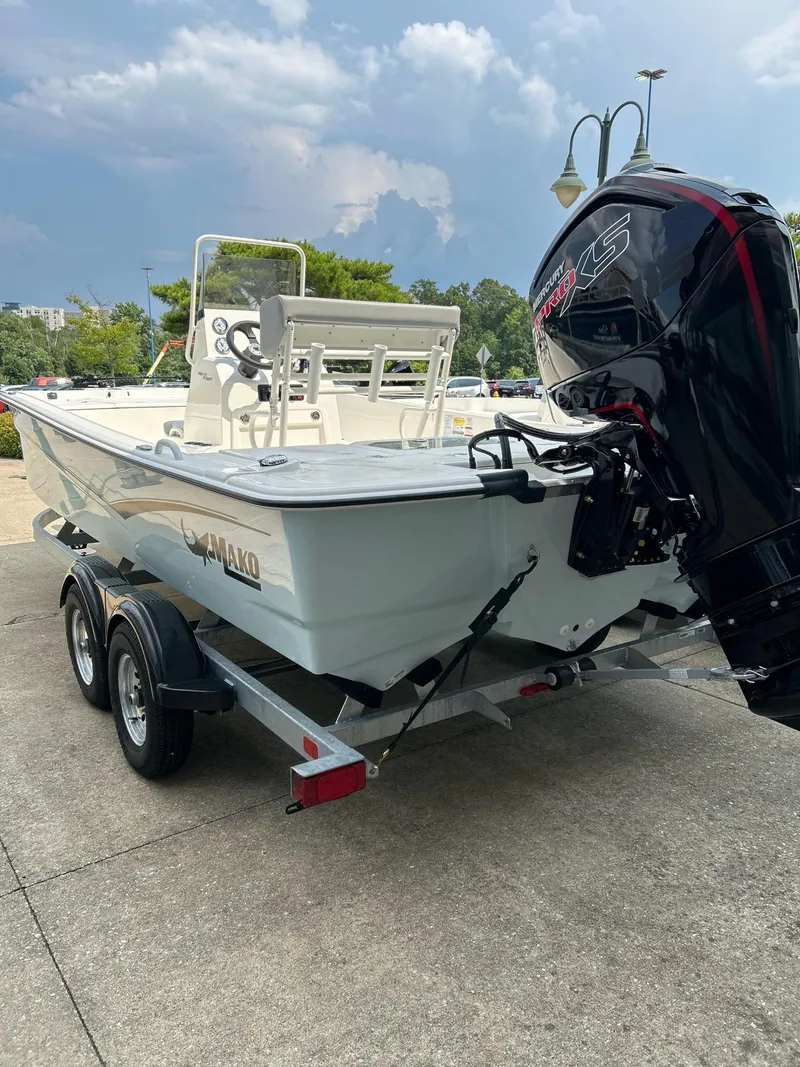 Slide: The Image of 2024 Mako Pro Skiff 19 CC boat on trailer with powerful outboard motor. - 4