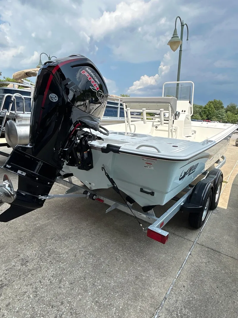 Slide: The Image of 2024 Mako Pro Skiff 19 CC boat with powerful outboard motor on trailer. - 6