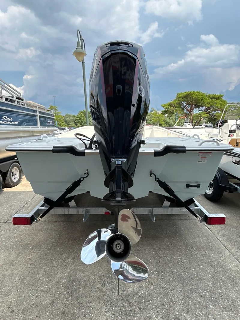 Slide: The Image of 2024 Mako Pro Skiff 19 CC boat with outboard motor on trailer. - 7