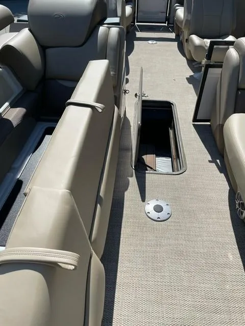 Slide: The Image of 2024 Regency 230 DL3 boat interior with open storage compartment. - 12