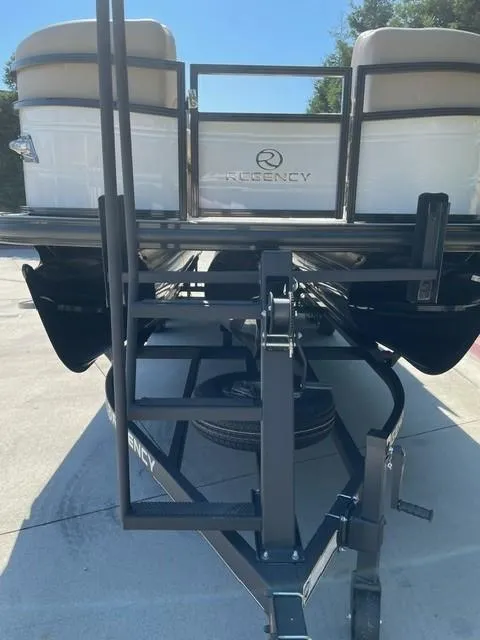 Slide: The Image of 2024 Regency 230 DL3 pontoon boat, rear view with trailer and ladder. - 6