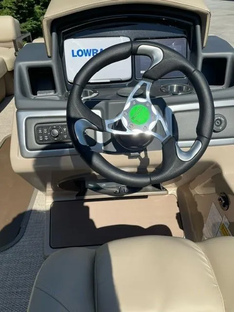 Slide: The Image of 2024 Regency 230 DL3 boat steering console with Lowrance display. - 7