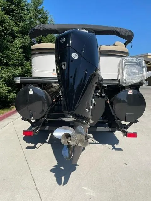 Slide: The Image of 2024 Regency 230 DL3 pontoon boat rear view with outboard motor. - 8