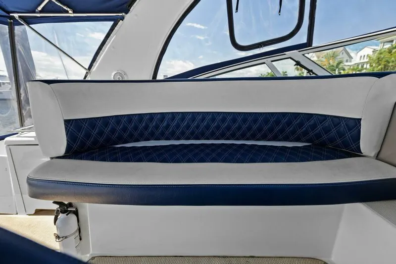 Slide: The Image of 2002 Cruisers Yachts 3672 Express interior seating with blue and white upholstery. - 13