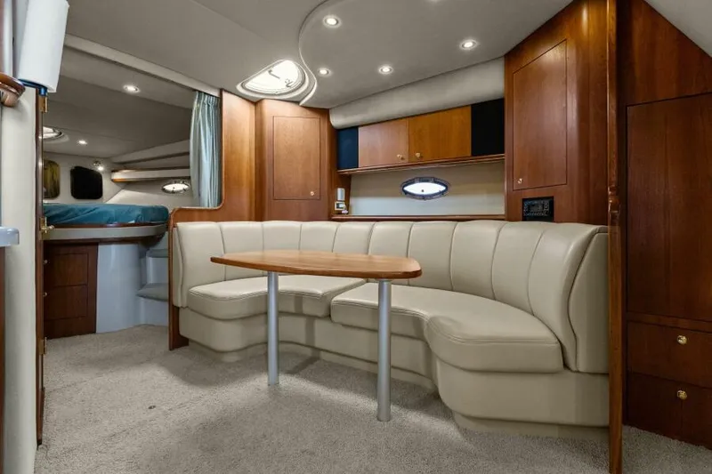 Slide: The Image of Luxurious interior of 2002 Cruisers Yachts 3672 Express with plush seating and wooden accents. - 25