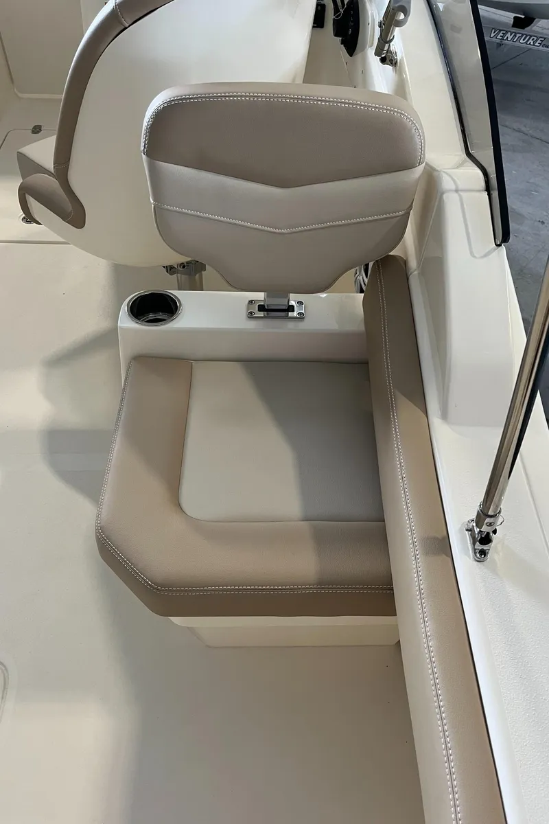 Slide: The Image of 2024 Scout 215 Dorado boat seat with beige upholstery and cup holder. - 15
