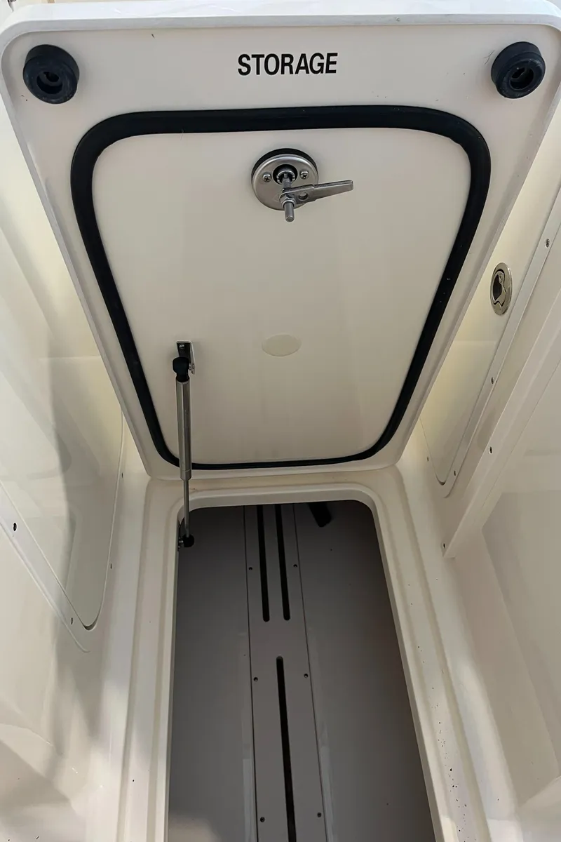 Slide: The Image of 2024 Scout 215 Dorado storage compartment with secure latch. - 16