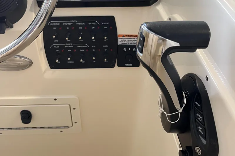 Slide: The Image of 2024 Scout 215 Dorado boat control panel and throttle. - 17