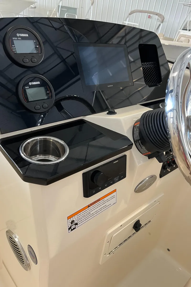 Slide: The Image of 2024 Scout 215 Dorado boat dashboard with gauges and controls. - 19