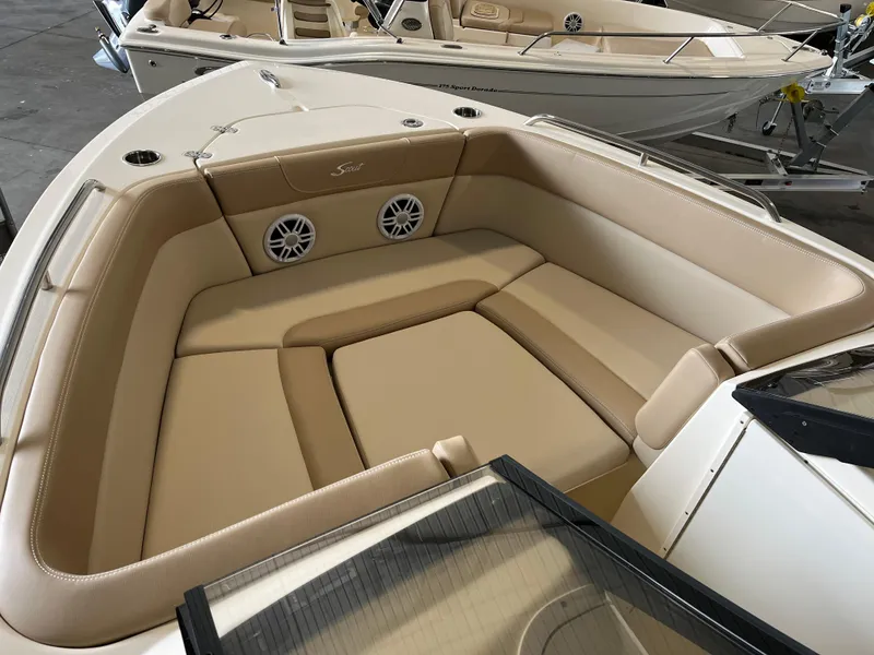 Slide: The Image of 2024 Scout 215 Dorado boat with beige cushioned seating and built-in speakers. - 3