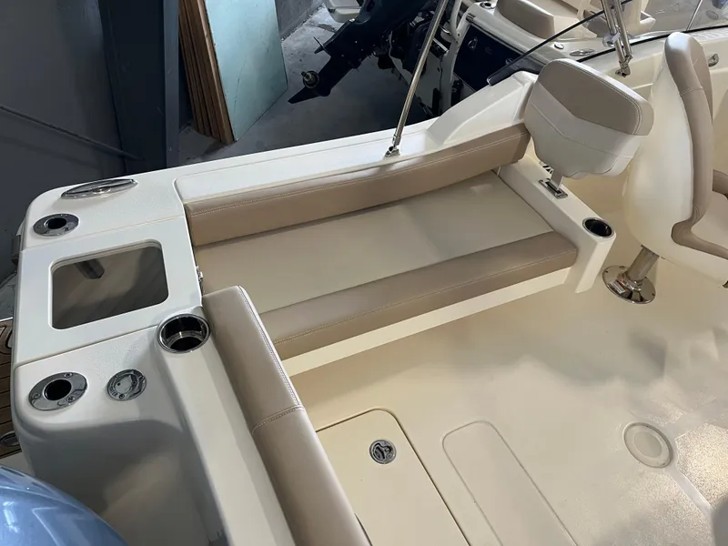 Slide: The Image of 2024 Scout 215 Dorado boat interior with beige seating and cup holders. - 4