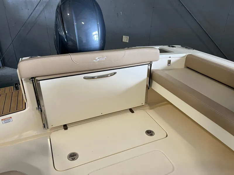 Slide: The Image of 2024 Scout 215 Dorado boat interior with seating and storage compartment. - 5