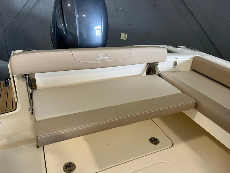 Slide: The Image of 2024 Scout 215 Dorado boat with beige seating and outboard motor. - 6