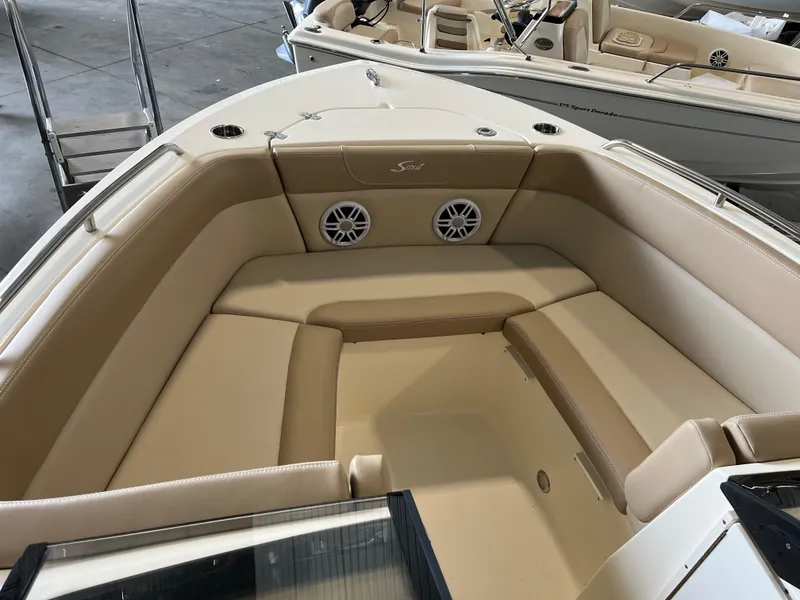 Slide: The Image of 2024 Scout 215 Dorado boat interior with beige seating and built-in speakers. - 7