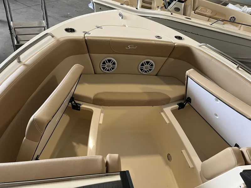 Slide: The Image of 2024 Scout 215 Dorado boat interior with beige seating and built-in speakers. - 8