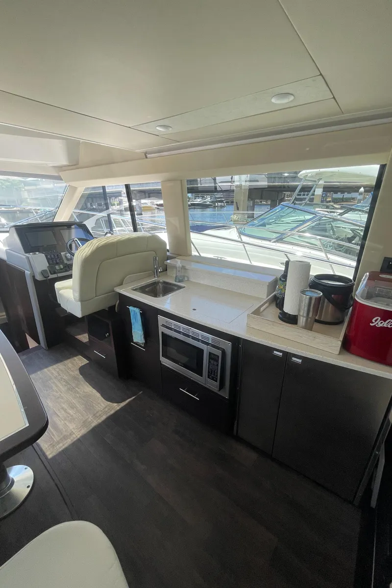 Slide: The Image of Interior of 2019 Regal 42 Grande Coupe yacht with modern kitchen and helm station. - 11