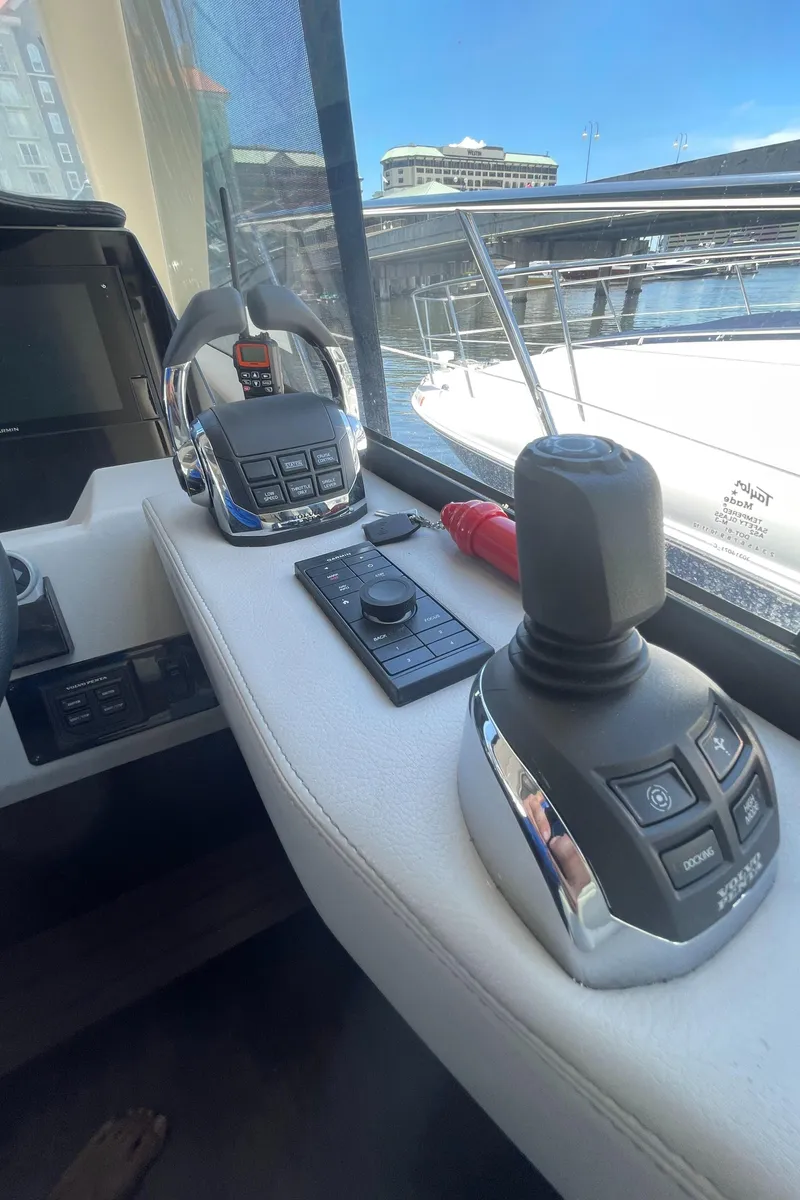 Slide: The Image of Control panel of a 2019 Regal 42 Grande Coupe yacht at a marina. - 15