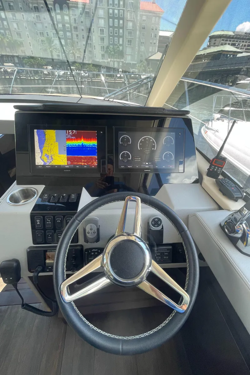 Slide: The Image of 2019 Regal 42 Grande Coupe yacht helm with advanced navigation displays. - 18