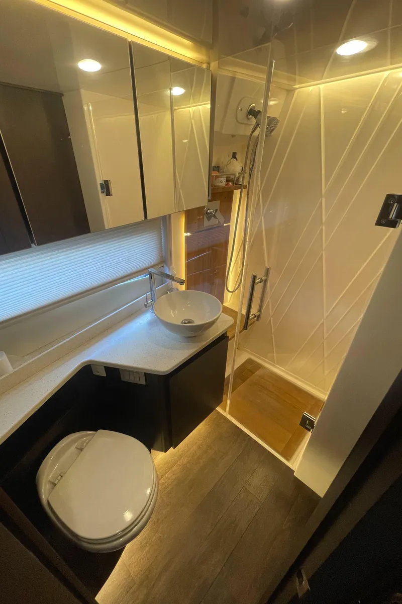 Slide: The Image of Modern bathroom in 2019 Regal 42 Grande Coupe yacht with shower, sink, and toilet. - 21