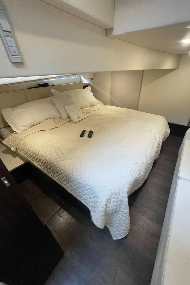 Slide: The Image of Luxurious bedroom in 2019 Regal 42 Grande Coupe yacht with cozy bedding. - 24