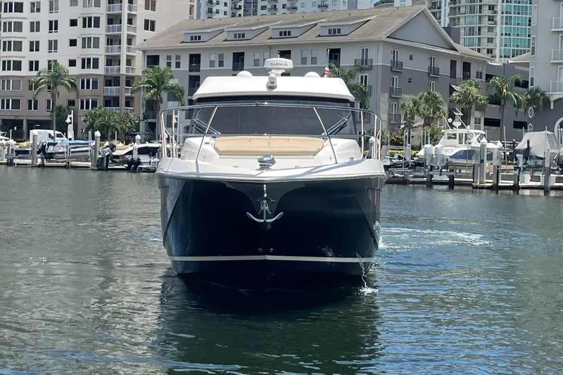 Slide: The Image of 2019 Regal 42 Grande Coupe yacht docked in a marina. - 33