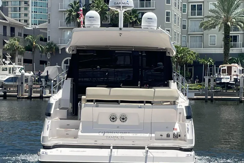 Slide: The Image of 2019 Regal 42 Grande Coupe yacht docked in marina, rear view. - 35