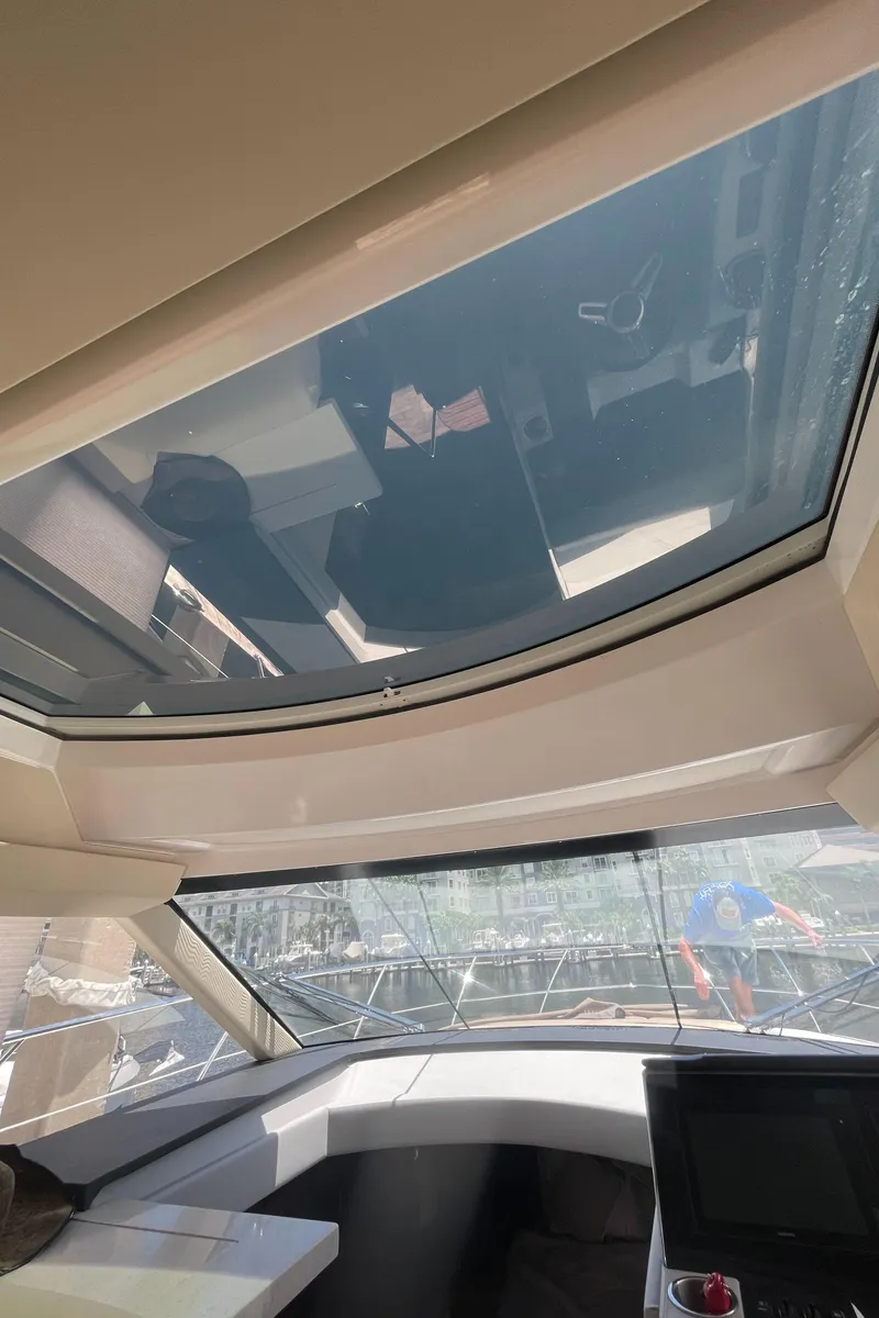 Slide: The Image of Interior view of 2019 Regal 42 Grande Coupe yacht with sunroof and navigation system. - 38