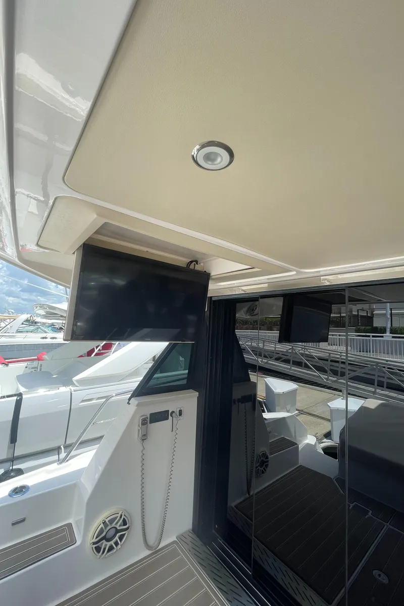 Slide: The Image of 2019 Regal 42 Grande Coupe yacht interior with TV and seating area. - 39