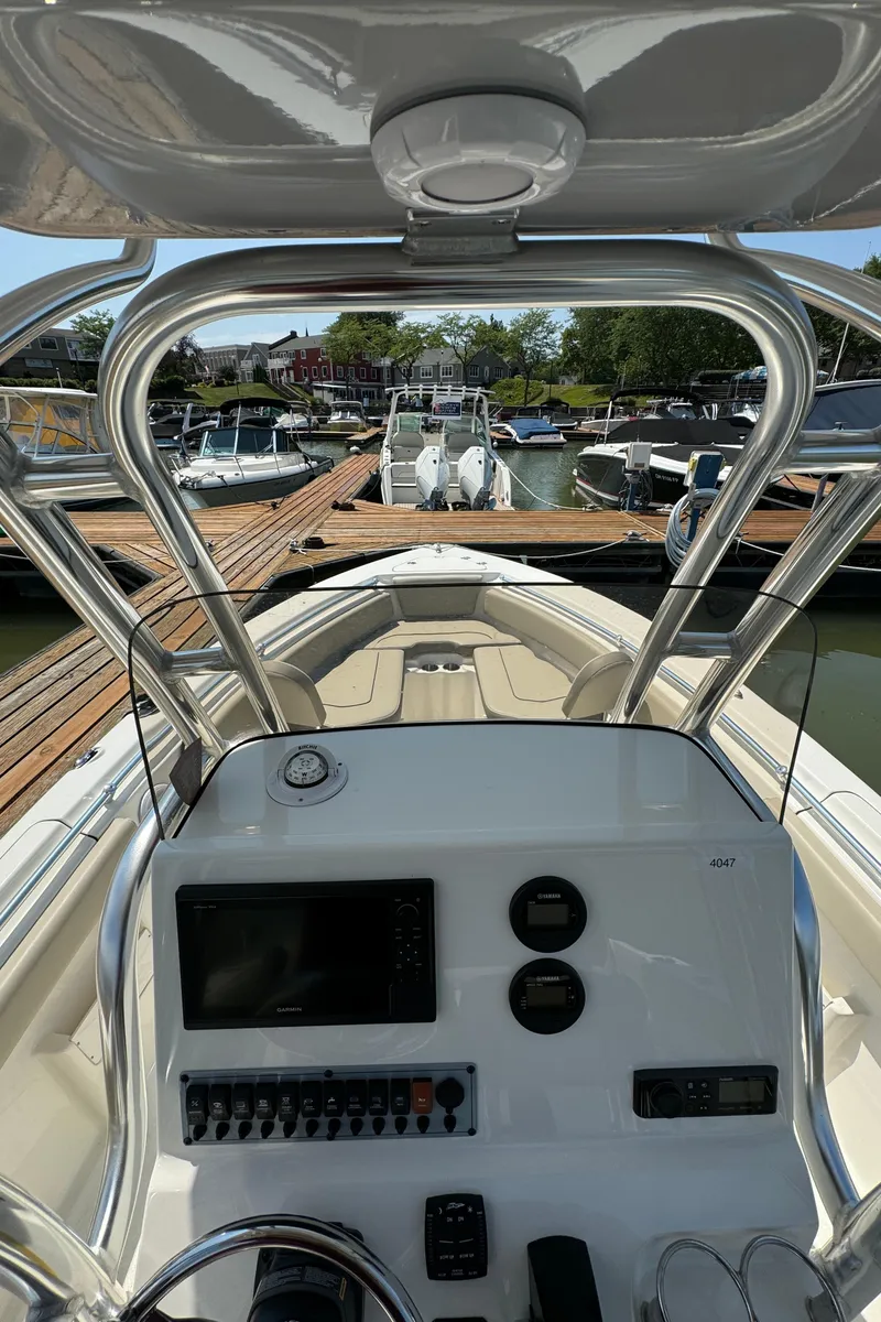 Slide: The Image of 2023 Key West 239 FS boat dashboard and controls at a marina. - 10