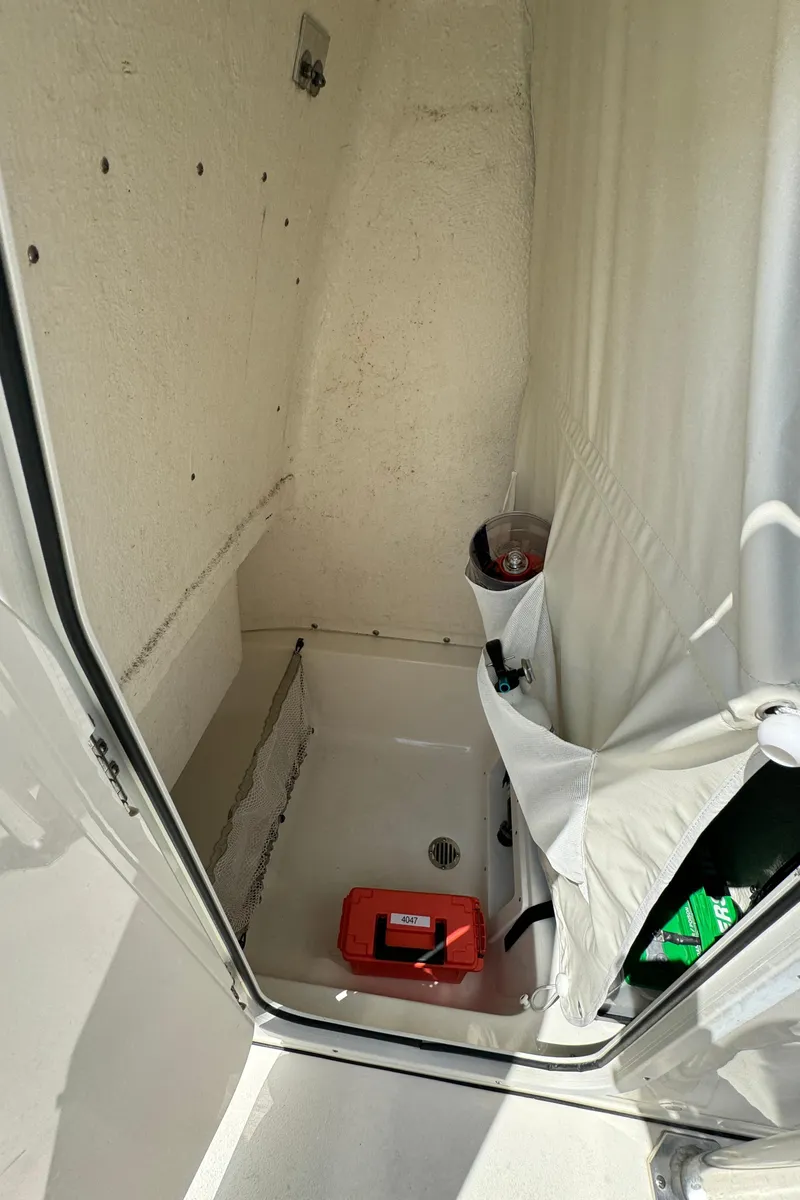 Slide: The Image of 2023 Key West 239 FS boat interior storage compartment with safety equipment. - 11