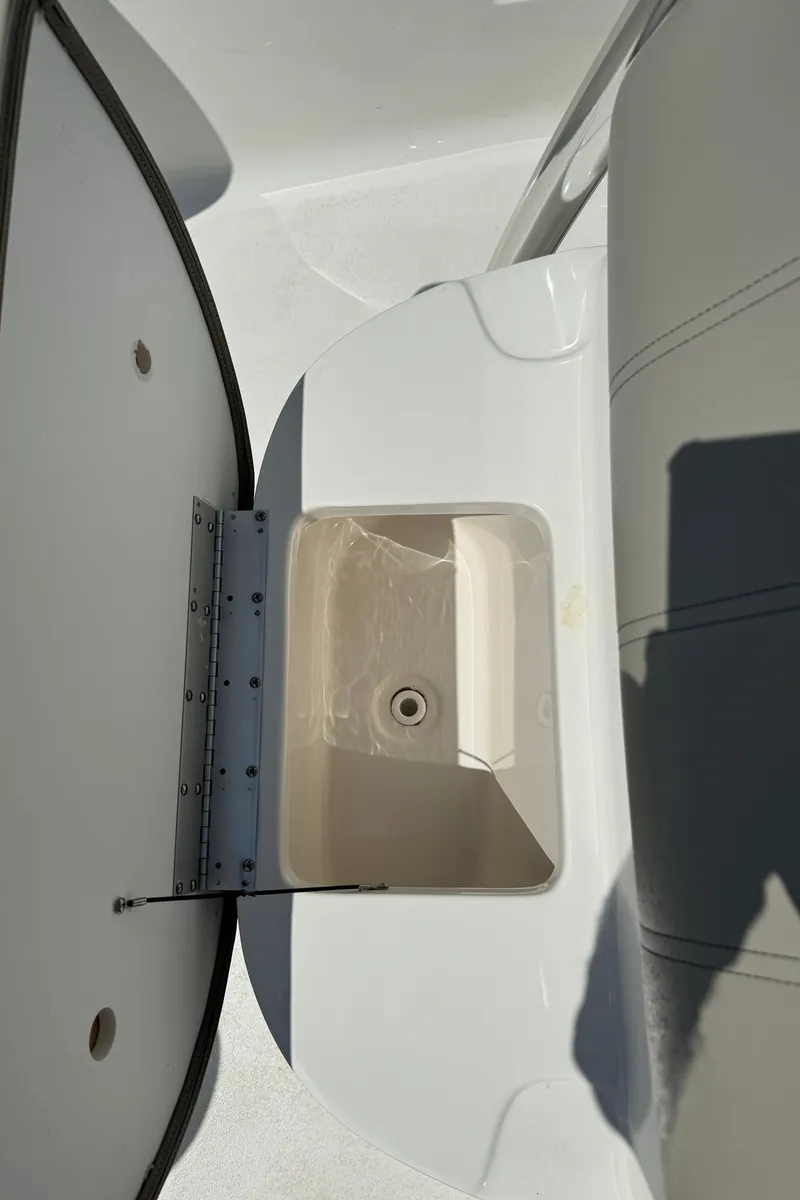 Slide: The Image of 2023 Key West 239 FS boat storage compartment with open lid. - 14