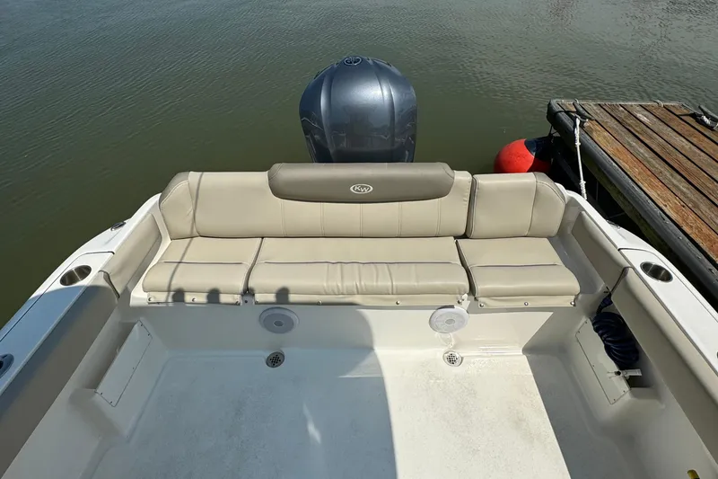 Slide: The Image of 2023 Key West 239 FS boat with rear seating and outboard motor. - 6