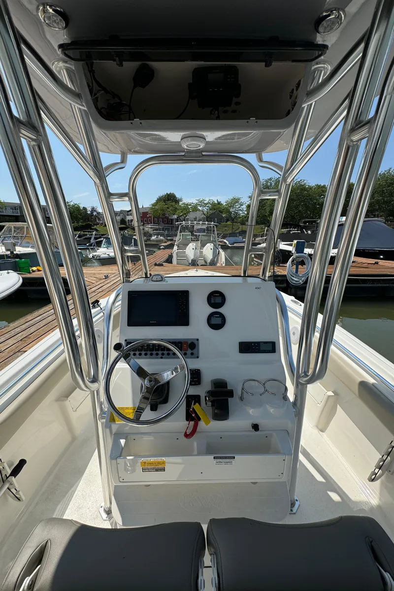Slide: The Image of 2023 Key West 239 FS boat dashboard and controls at a marina. - 7