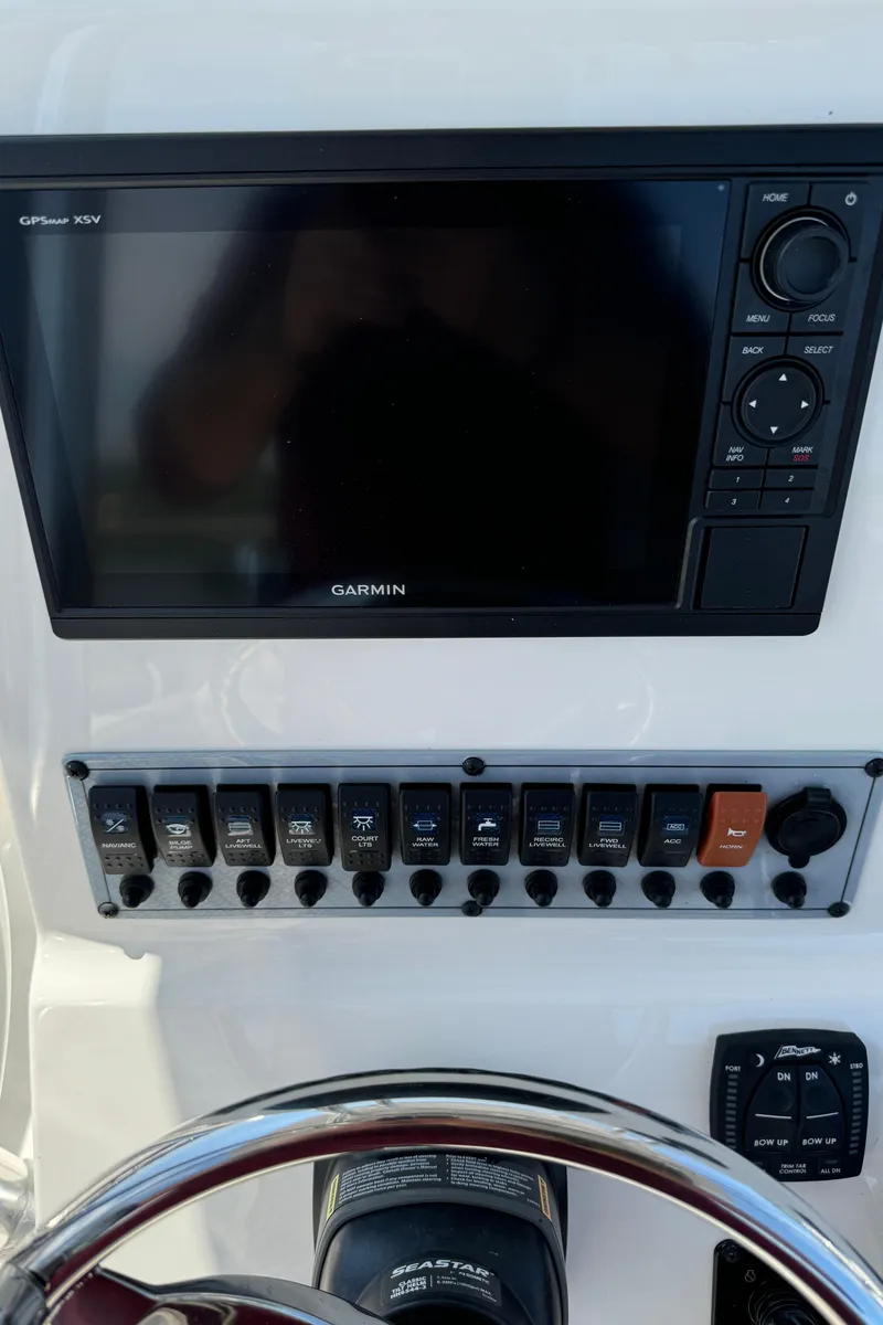 Slide: The Image of 2023 Key West 239 FS boat dashboard with Garmin GPS and control panel. - 8