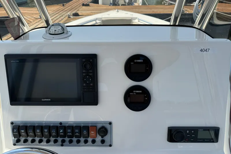 Slide: The Image of 2023 Key West 239 FS boat dashboard with Garmin display and Yamaha gauges. - 9