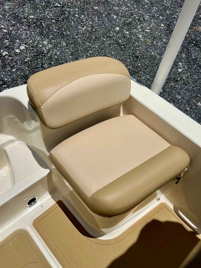 Slide: The Image of 2019 Scout Sportfish 175 beige cushioned seat on deck. - 14