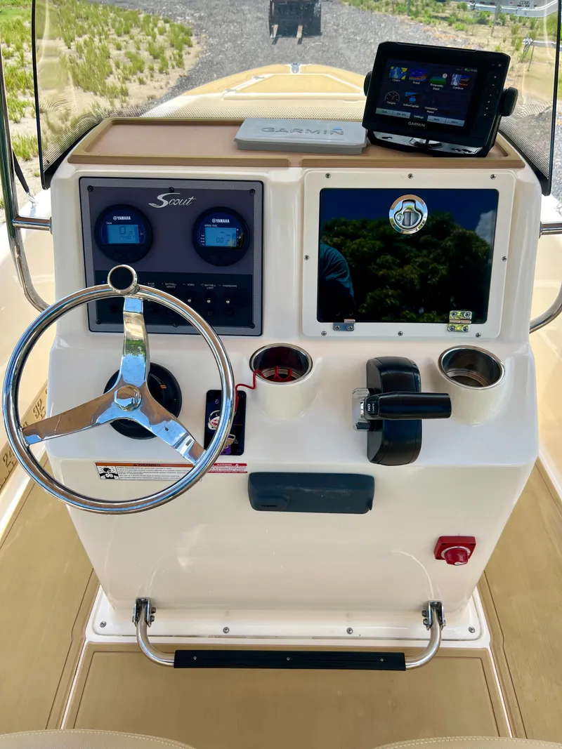 Slide: The Image of 2019 Scout Sportfish 175 boat console with steering wheel and navigation system. - 17