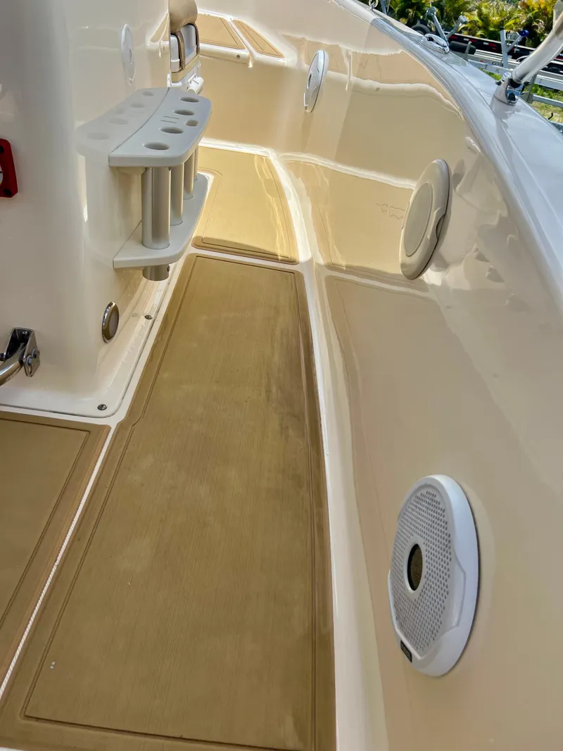 Slide: The Image of 2019 Scout Sportfish 175 boat interior with rod holders and speakers. - 18