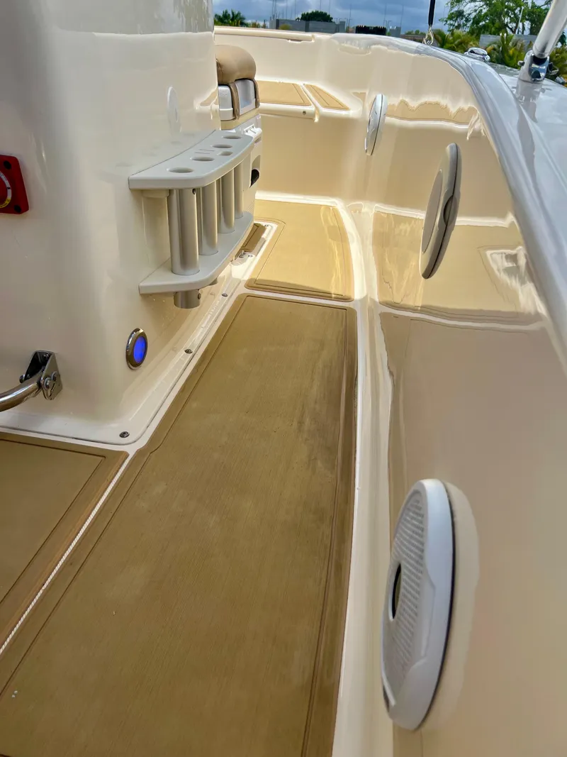 Slide: The Image of 2019 Scout Sportfish 175 boat interior with rod holders and speakers. - 21