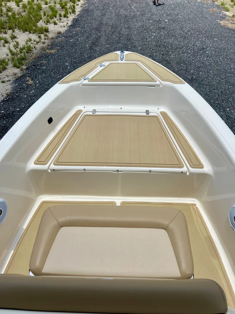 Slide: The Image of 2019 Scout Sportfish 175 boat deck with tan seating and storage compartments. - 22