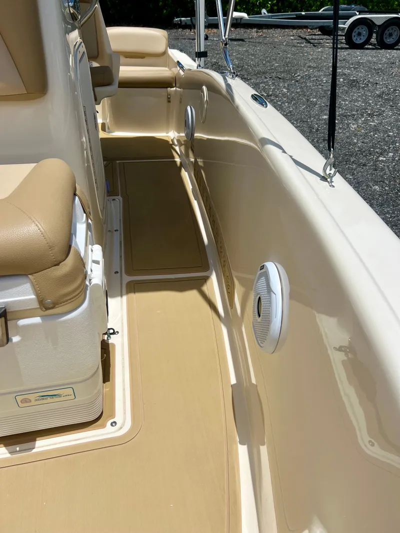 Slide: The Image of 2019 Scout Sportfish 175 boat interior with beige seating and flooring. - 26