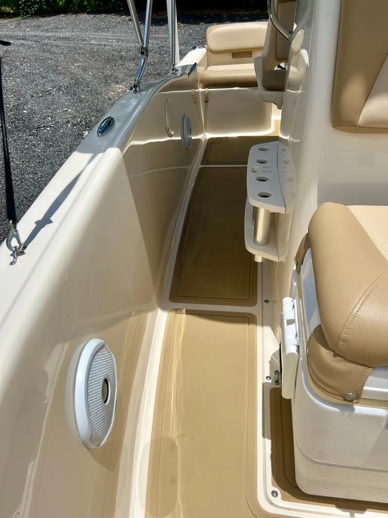 Slide: The Image of 2019 Scout Sportfish 175 boat interior with beige seating and white speakers. - 27