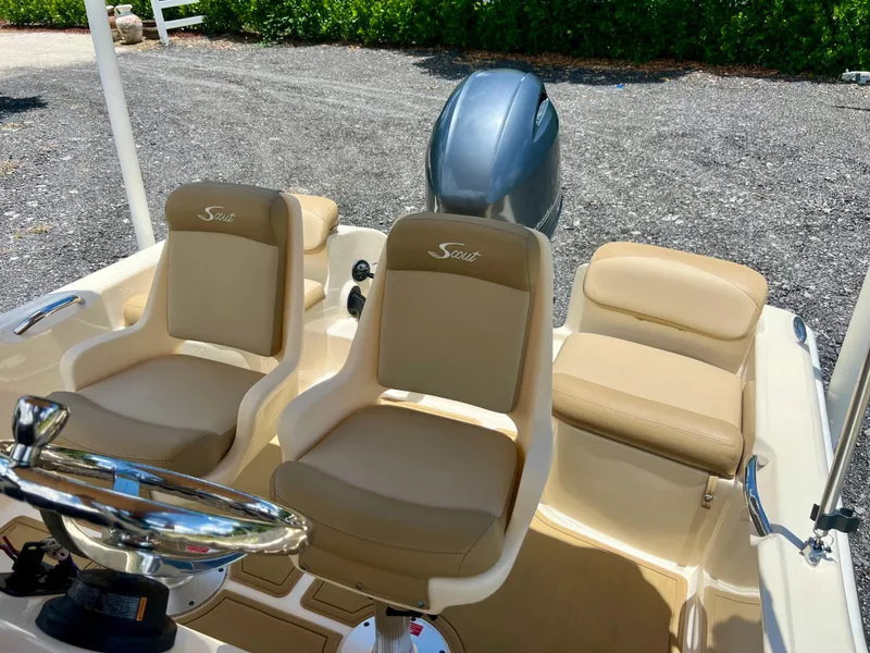 Slide: The Image of 2019 Scout Sportfish 175 boat interior with beige seating and steering wheel. - 28
